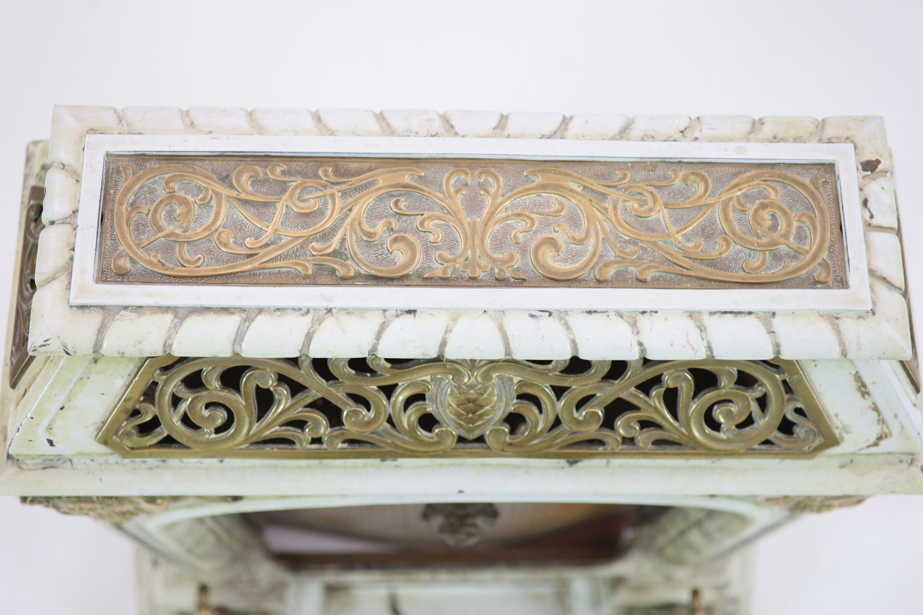 A late 19th century French Art Nouveau enamelled cast iron and brass fire surround H 91cm. W 82cm. D 46cm.